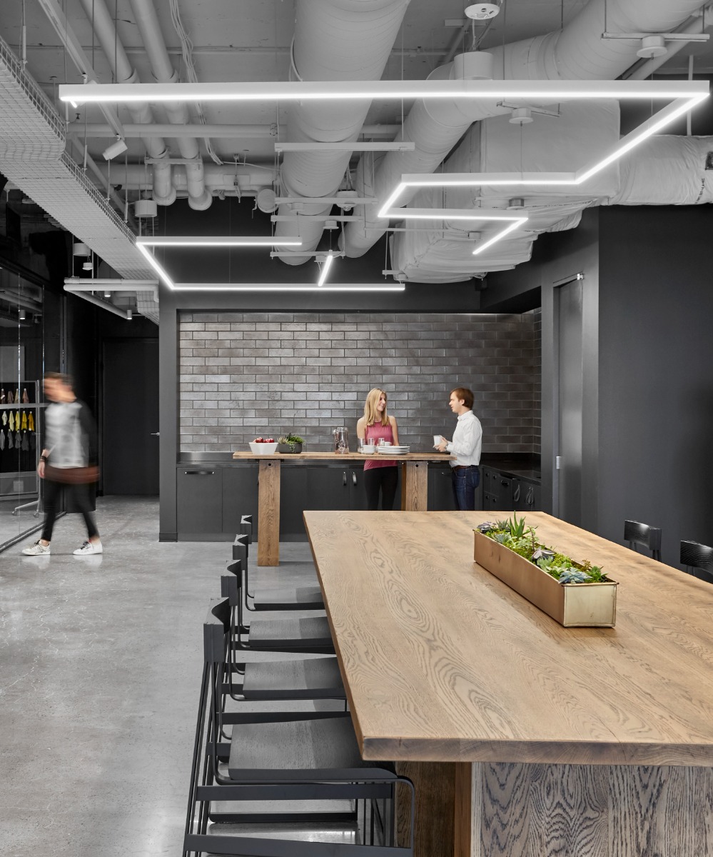 Linear suspension lighting shown with 90-degree angled connectors can make original geometric designs as shown in this retail space