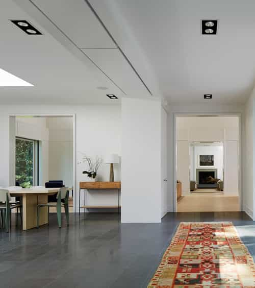 Flanged square LED recessed lights with white trim light a path from apartment mailboxes to an elevator in the Wilton Court Apartments lobby.