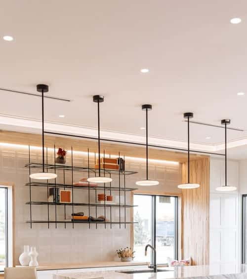 Trimless round recessed LED downlights provide ambient general lighting over an office kitchen and breakroom with an LED pendant for task lighting.