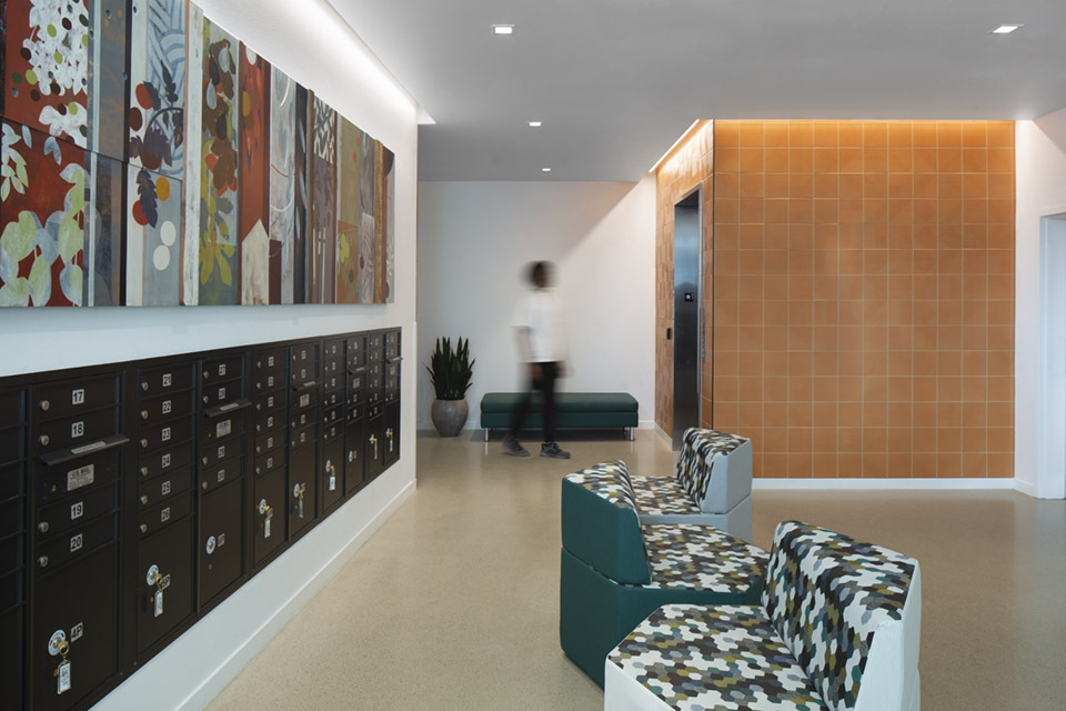 Square recessed lights illuminate an apartment complex lobby