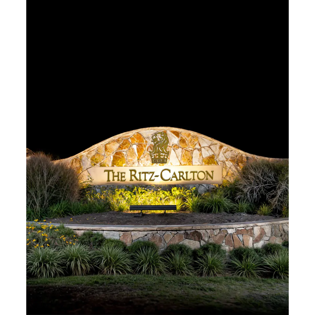 An outdoor LED sign light illuminates the La Conterra subdivision sign at the sub-development entrance in Georgetown, Texas.